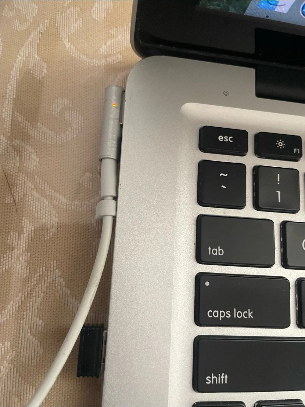 Apple MacBook Pro Silver with Black Keyboard and Sticker